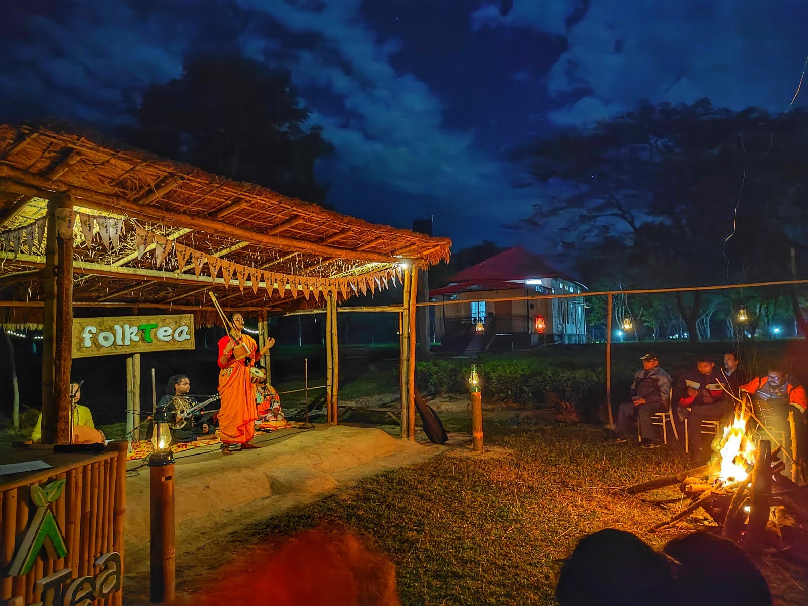 Folk ensemble performing on the open-air stage at night